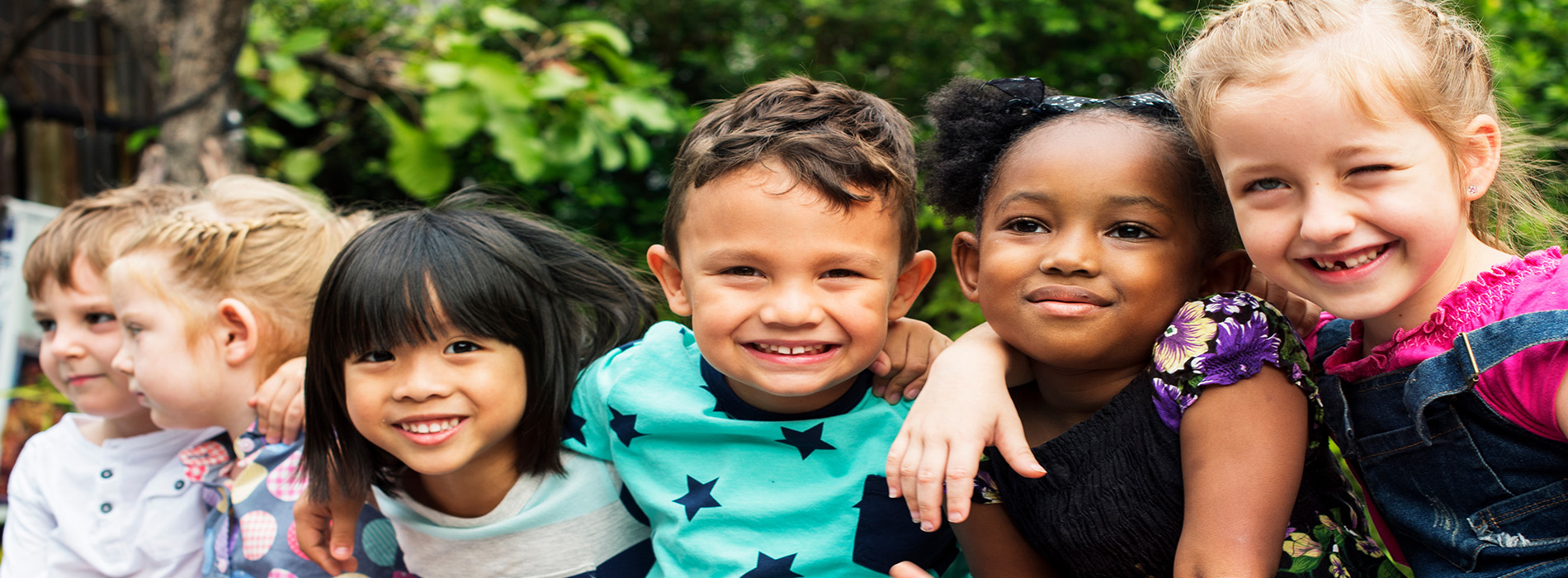 The image shows a group of children posing together for a photograph.