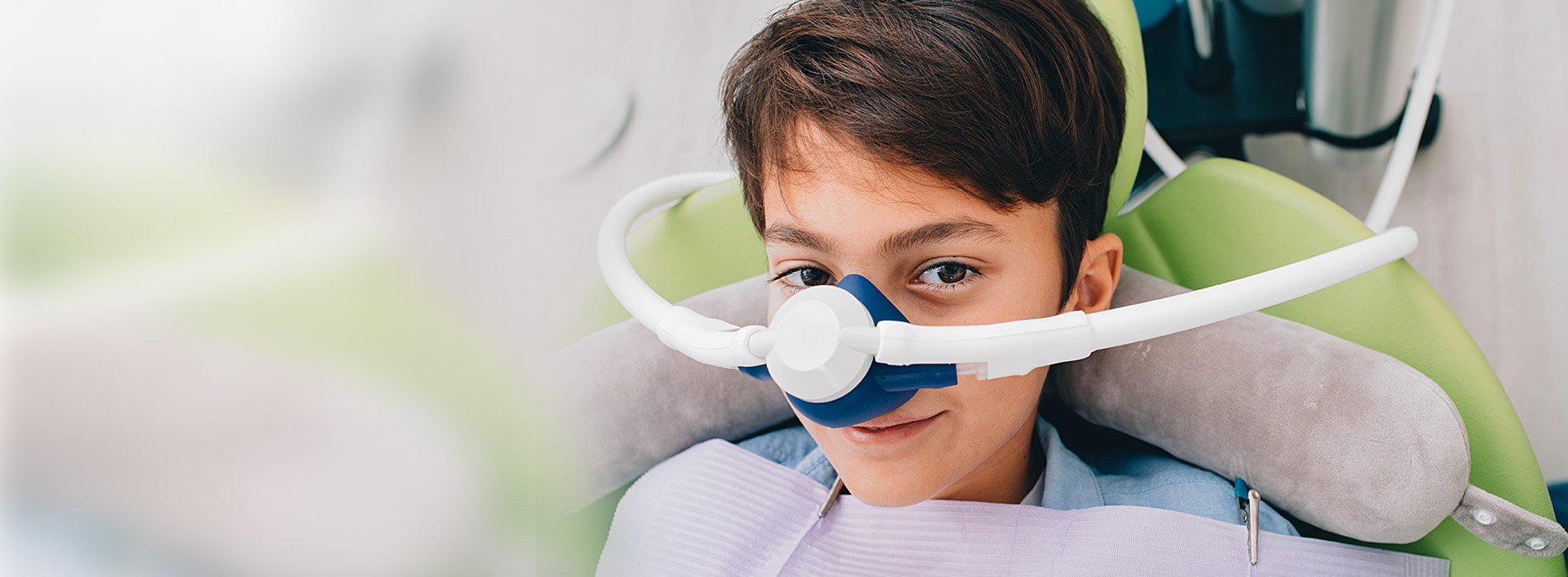 A young individual wearing a dental brace and sitting in a dentist s chair, with the focus on oral health care.